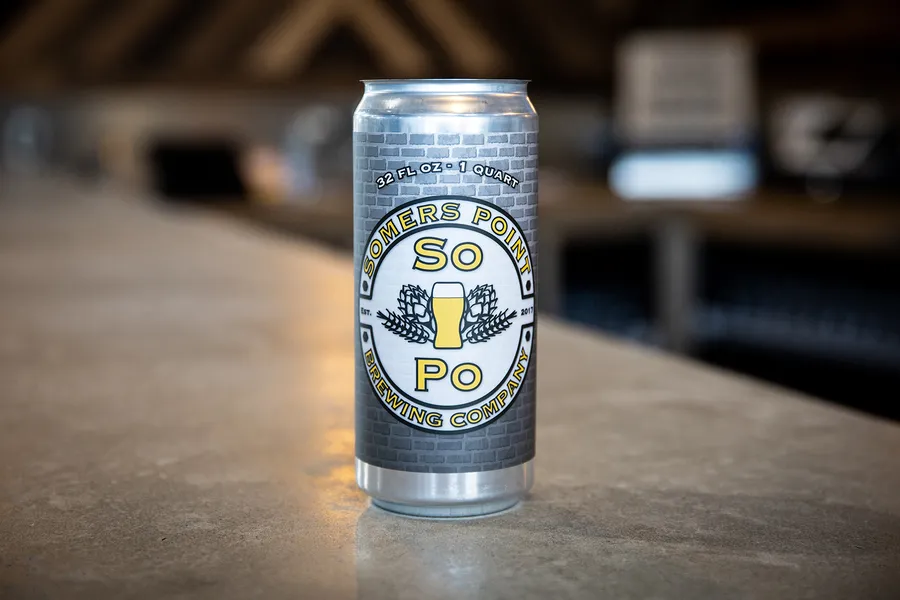 A Somers Point Brewing can on the wooden bar