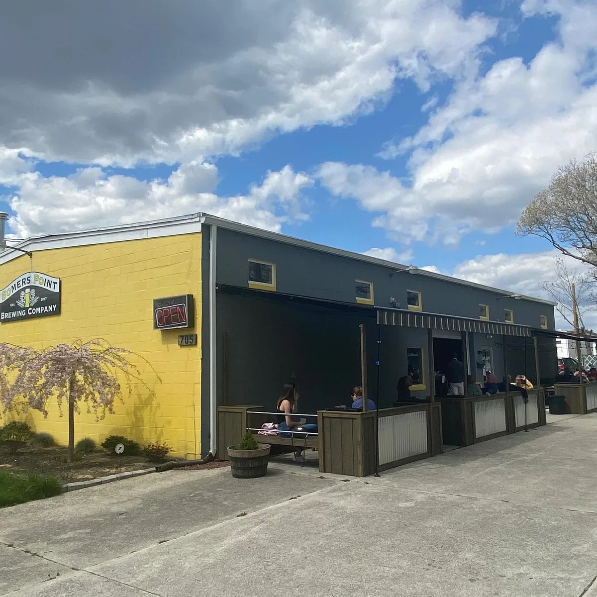 The yellow Somers Point Brewing building and its covered patio on West New York Avenue