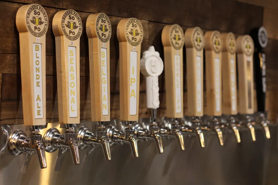 Wooden SoPo tap handles behind the bar